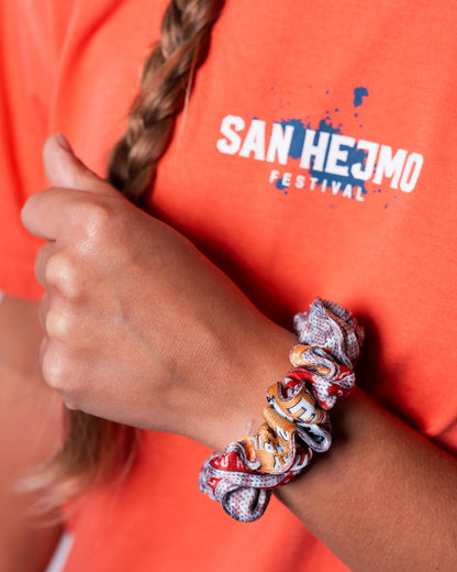 Der Scrunchie aus der Upcycling-Kollektion an einem Handgelenk. Er besteht aus Festivalbändchen aus dem Jahr 2024.